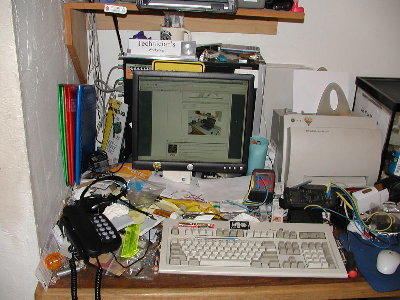 Desktop is buried under the workbench clutter