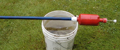 Test setup.  Marshmallow Cannon with 48 inch long 3/4 inch PVC barrel.  5 Gallon Soy Sauce poly bucket.  Water