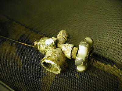 Valve removed from a propane tank showing the vent tube on the left side of the picture.