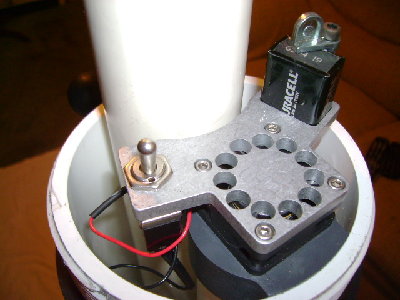 view of the fan and battery,  mixes the fuel and air, also pushes out the spent gas after you fire