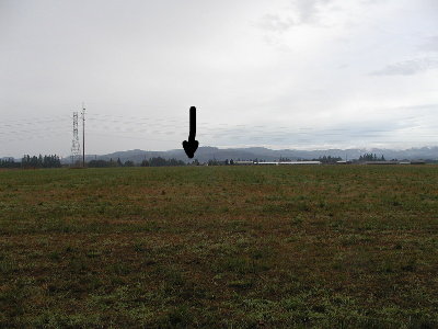 This is a view down range.  There are about 6 flags on wires marking the landings out in the field. The arrow points to the red marker in the next photo.  We did go over the powerlines.