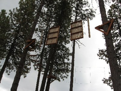 Shot of part of the high ropes course. This is the back side of the two rock climbing walls.