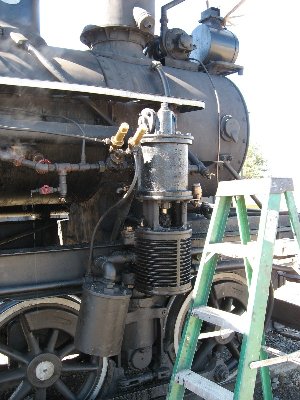 This air compressor on the side of the engine gave some trouble.  They got it working.  It is for the brakes.  It runs off steam and provides 100 PSI.  The steam turbine and dynamo for my project can be seen on top between the headlight and stack.