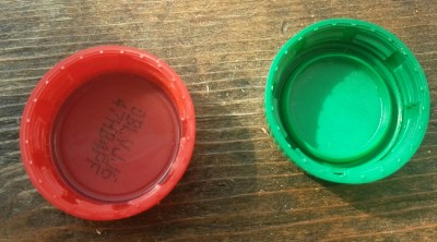 The mountain dew cap (on the right) has a beveled ring on the inside that prevents O-rings or gaskets from fitting
