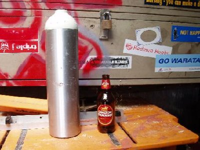 The oxygen bottle with a beer bottle as size reference.