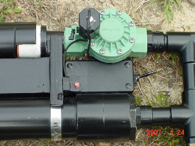 The fire control mechanism.The toggle is safety and red is fire.