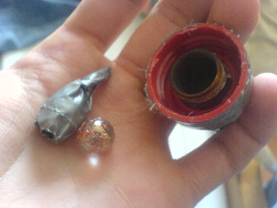 Two marbles, one of em taped in and the backside of the barrel with the bottle cap. You can see the pipe became a bit burned.....