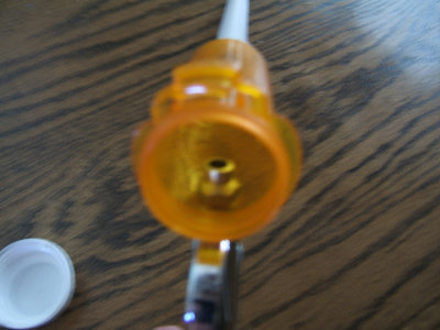 The blowgun came with this nozzle, I drilled it to make the hole much larger for better air flow.<br />I drilled a hole in the pill bottle, and used the 1/8&amp;quot; nozzle attachment to bolt the bottle to the blowgun. Sorry for the  bad image focus.