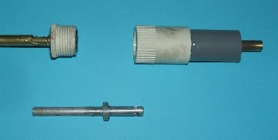 Prototype in disassembled form, from left to right barrel section with ammunition feed slot and rubber damper in male thread, bolt section with cast epoxy stopper and rear section with brass tube air feed that also doubles as a bolt housing