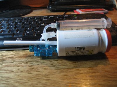 The blue thing is the fuel cell. The chamber is a tylenol bottle and the barrel is a pen tube. The syringe is 10ml in volume.