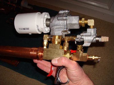 Nice thing about this design is that the trigger is still very comfortable whether mounted to the gunstock or not.  Also, the whole thing is still light enough to easily hold in one hand (and this one still has the oversized chamber still on it).