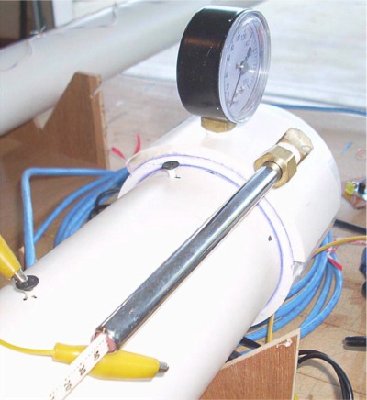 Tire pressure gauge (peak pressure recoding gauge) fitted to a chamber using a compression fitting. The two gauges are tapped into a triple layer of PVC.